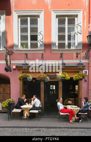 La città vecchia di Vilnius, vista di giovani seduto fuori da un bar in Pilies Gatve - La direttrice principale nel centro della città vecchia di Vilnius, Lituania. Foto Stock