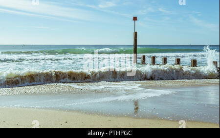 Le onde lavare oltre i pennelli a Boscombe a Bournemouth, Regno Unito. Adottate il 7 ottobre 2018. Foto Stock