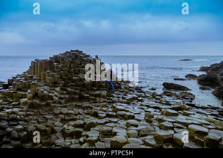 I turisti a piedi sulla famosa giganti' Causeway pietre in Irlanda del Nord Foto Stock