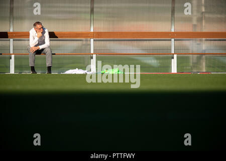 Il 10 ottobre 2018, Baden-Wuerttemberg, Stoccarda: Michael Reschke, direttore sportivo del VfB Stuttgart, si siede su un banco a terra di formazione durante la prima sessione di formazione con la nuova trainer Weinzierl. Foto: Sebastian Gollnow/dpa Foto Stock