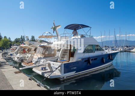 Barche a motore di lusso, barche a vela e yacht ormeggiati nel porto di Yvoire lungo il lago di Ginevra / Lac Leman, Alta Savoia, Francia Foto Stock