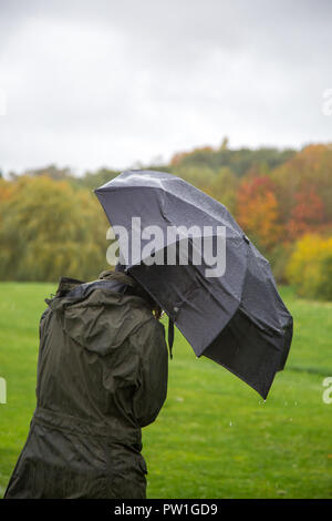 Kidderminster, Regno Unito. Xii Ottobre, 2018. Regno Unito: meteo è molto umido e ventoso! Mentre temperature più miti potrebbero essere tentati di noi all'aperto, i visitatori di un parco locale a Kidderminster hanno a brave magie pesanti di pioggia e la sempre più forte presenza di raffiche di vento di questa mattina. Credito: Lee Hudson/Alamy Live News Foto Stock