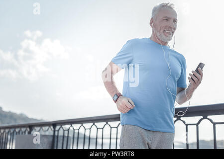 Felice la persona di sesso maschile facendo attività di mattina Foto Stock