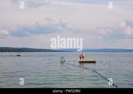 Una famiglia salti in Lago Skaneateles, Skaneateles, New York, Stati Uniti d'America, 14 giugno 2013. Foto Stock