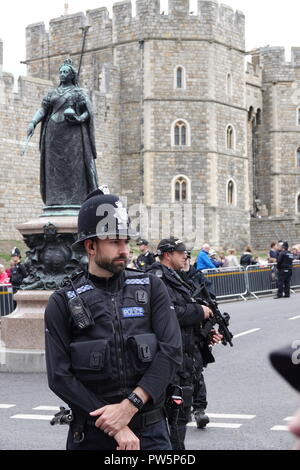 Windsor, Regno Unito. Xii Ottobre, 2018. Polizia armata in guardia dalla regina Victoria statua in Windsor High Street per il matrimonio di S.A.R. la Principessa Eugenie e Jack Brooksbank in alla cappella di San Giorgio, il Castello di Windsor, Regno Unito. Credito: Andy Stehrenberger/Alamy Live News Foto Stock