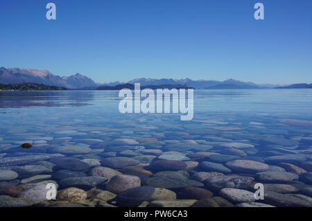 Le acque calme su Nahuel Huapi Lago di Bariloche circondata da belle montagne e il cielo blu, Argentina, Sud America. Foto Stock