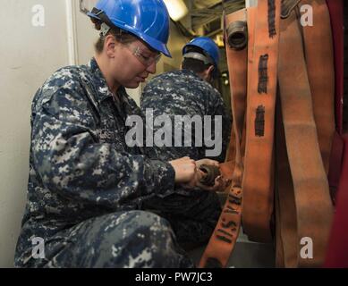 PORTSMOUTH, Va. (sett. 22, 2017) di aviazione di Boatswain Mate (movimentazione) terza classe Falsetti Shelby, da Ellenton Fla., esegue le operazioni di manutenzione su un tubo flessibile di incendio a bordo della portaerei USS Dwight D. Eisenhower CVN (69) (IKE). Ike è sottoposto a una prevista disponibilità incrementale (PIA) a Norfolk Naval Shipyard durante la fase di manutenzione della flotta ottimizzato il piano di risposta (OFRP). Foto Stock