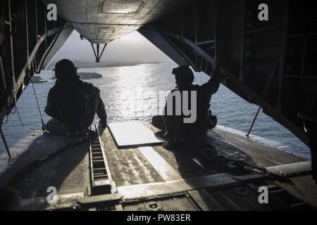 Mar dei Caraibi (ott. 2, 2017) Marine Sgt. Andrew Mocarshi (sinistra) e Marine Cpl. Evan Ziska, assegnato a mezzo marino Tiltrotor Squadron 162, imbarcato a bordo dell'assalto anfibio nave USS Kearsarge (LHD 3), sedersi sul retro di un CH-53E Super Stallion dopo la conduzione di rinforzo strutturale della diga Guajataca in Quebradillas, Puerto Rico. Kearsarge è assistere con i soccorsi dopo il passaggio dell uragano Maria. Il Dipartimento della difesa è il supporto di FEMA, il piombo agenzia federale, per aiutare le persone colpite dall'uragano Maria per ridurre al minimo la sofferenza ed è un componente del complessivo whol Foto Stock