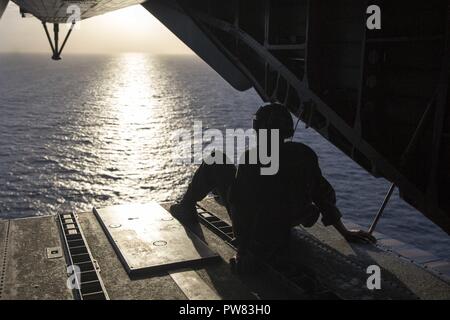 Mar dei Caraibi (ott. 2, 2017) Marine Cpl. Evan Ziska assegnato a mezzo marino Tiltrotor Squadron 162, imbarcato a bordo dell'assalto anfibio nave USS Kearsarge (LHD 3), si trova nel retro di un CH-53E Super Stallion dopo la conduzione di rinforzo strutturale della diga Guajataca in Quebradillas, Puerto Rico. Kearsarge è assistere con i soccorsi dopo il passaggio dell uragano Maria. Il Dipartimento della difesa è il supporto di FEMA, il piombo agenzia federale, per aiutare le persone colpite dall'uragano Maria per ridurre al minimo la sofferenza ed è un componente del complessivo intero-di-risposta del governo sforzo. Foto Stock