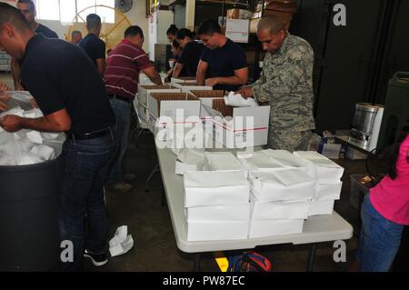 EFAC - Emergenza famiglia Centro assistenza - lavoratori, aviatori e voluteers preparare e distribuire tanto bisogno di cibo e generi di prima necessità ai membri dell'156Airlift Wing durante il weekend trapano ott. 15, 2017 a Muniz aria base nazionale, Puerto Rico. Foto Stock