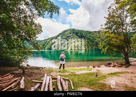 Ragazza sulla riva di uno dei più incredibili laghi di Plitvice in Croazia. Unità con la natura vergine. Foto Stock