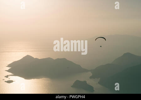 Parapendio oltre le montagne in Oludeniz Foto Stock