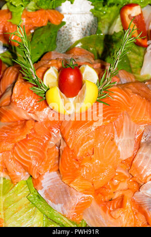 Sashimi sushi. Salmone crudo pezzi disposto con il limone, pomodori, lattuga, rosmarino, salute mangiare concept Foto Stock