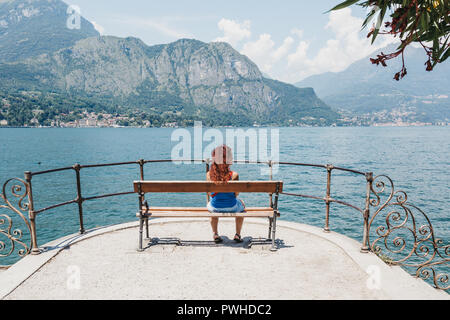 Bellagio, Italia - Luglio 06, 2017: Donna relax su una panchina di Bellagio, affacciato sul lago di Como. Bellagio è spesso indicata come la Perla del Lago Foto Stock
