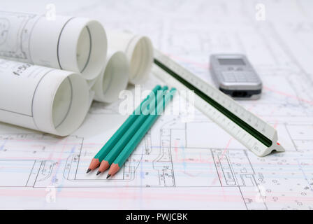 Arrotolata piani architettonici e utensili di disegno Foto Stock