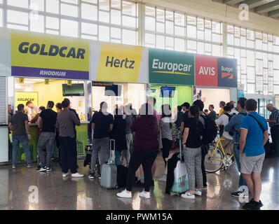 Le persone in fila al desk di noleggio auto di Barcellona El Prat Airport Terminal. Spagna Foto Stock