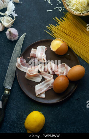 La pasta alla carbonara ingretients: uova, aglio e pancetta e formaggio Foto Stock