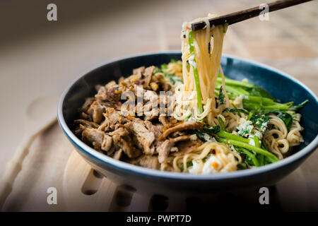 Ciotola di asian tagliatelle con carne di maiale , verdure e funghi Foto Stock