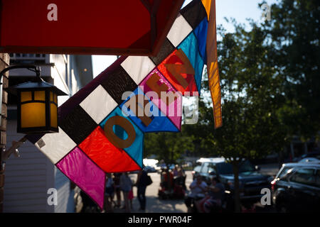 Colored open for business shop sign on a flag - Saugatuck, MI Foto Stock