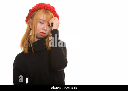 Giovani carino donna asiatica avente mal di testa e la sensazione di essere sottolineato Foto Stock