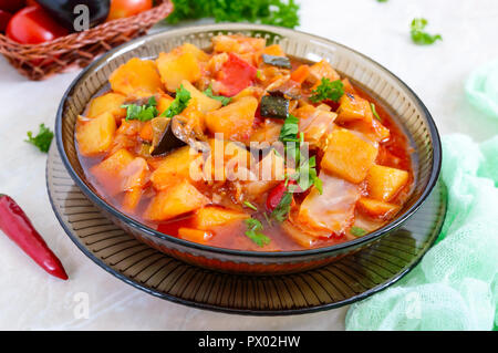 Delizioso stufato vegetale in una ciotola di vetro. Un piatto popolare di molti paesi del mondo. Menù vegetariano Foto Stock