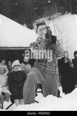 In inverno i 1940s. Una giovane donna è filmare il curling championships succedendo ad Åre in Svezia. 1940s. Foto Stock