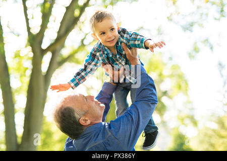Nonno e littleson divertirsi nel parco Foto Stock