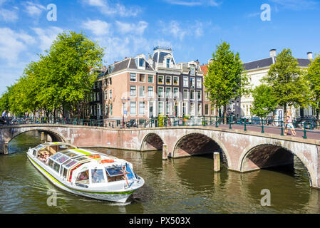 Amsterdam canal boat andare sotto i ponti di Leidsegracht canal in corrispondenza della giunzione con canale Keizergracht Amsterdam Paesi Bassi Olanda UE Europa Foto Stock