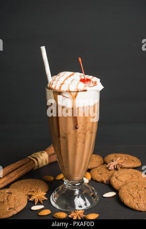 Frullato di cioccolato con banane e biscotti sul legno scuro sfondo Foto Stock