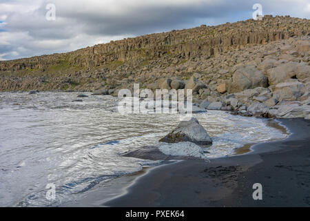 Spiaggia di sabbia nera e le rocce vicino a Detifoss cascata nel Jokulsargljufur National Park in Nord Islanda Foto Stock