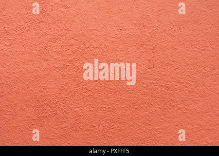 Parete in stucco - Maroon red stucco parete testurizzata sfondo con luce naturale. Foto Stock