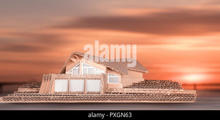 Modello di cottage di lusso contro il cielo al tramonto. Miniatura di cartone di casa moderna Foto Stock