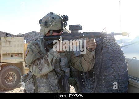 Travis privato erbaccia, assegnato alla società di sede, 150° Battaglione ingegnere, Mississippi Esercito Nazionale Guardia, difende il perimetro durante una simulazione di attacco del tactical operations center Giugno 3, 2017, a Fort Irwin, California. (Mississippi Foto Stock