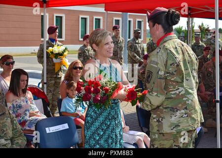 Audrey, Moglie del Ten. Col. Benjamin A. Bennett, il comandante uscente della 54ª Brigata Battaglione ingegnere, 173rd Brigata Aerea, riceve un mazzo di fiori rossi da un paracadutista durante la modifica del comando cerimonia alla Caserma del Din a Vicenza, Italia, 13 giugno 2017. Il 173rd Brigata Aerea, con sede in Vicenza, Italia, è l'esercito di contingenza Forza di risposta in Europa ed è in grado di proiettare le forze per condurre la piena gamma delle operazioni militari su tutto il territorio degli Stati Uniti, europeo centrale e comandi Africa aree di responsabilità. Foto Stock