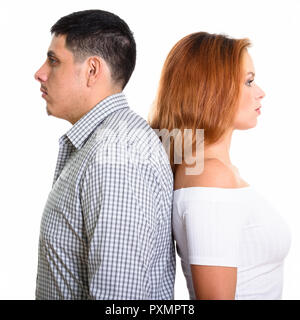 Studio shot della giovane coppia ispanica con schiena contro ogni altro Foto Stock