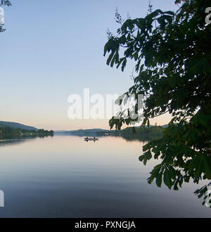 Gli uomini la pesca in barca a remi sul Coniston Water Parco Nazionale del Distretto dei Laghi, al tramonto, Cumbria, Regno Unito, GB Foto Stock