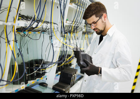 Immagine del tecnico di rete modem di collaudo in fabbrica Foto Stock