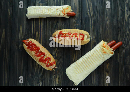 Il fast food.hot dog con salsa piccante e shawarma on dark backgrou Foto Stock