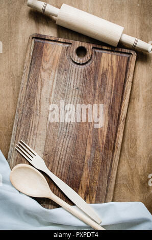 Cucina Background: matterello con carta asciugatutto o tovagliolo sulla tavola di legno sopra la tavola in legno rustico. Vista da sopra con lo spazio di copia Foto Stock