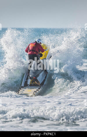 Un bagnino RNLI su un jetski al Fistral a Newquay in Cornovaglia. Foto Stock