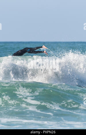 Regno Unito surf - un surfista tergi a Fistral Beach in Newquay in Cornovaglia. Foto Stock