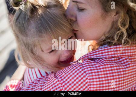 Madre consolante la sua figlia di pianto Foto Stock