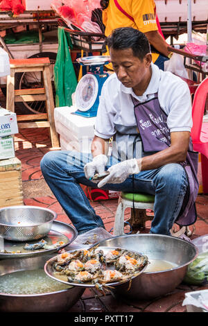 Bangkok, Tailandia - 25 Settembre 2018: l'uomo la preparazione di granchi di vendita ad un pesce di stallo Street, Chinatown ha molti venditori ambulanti. Foto Stock