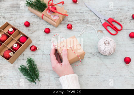 Donna impacchettare i regali di Natale, vista parziale Foto Stock