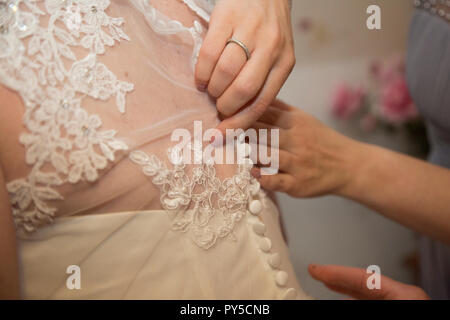 Close up della sposa avente il suo abito fatto prima di lei ottiene sposato Foto Stock