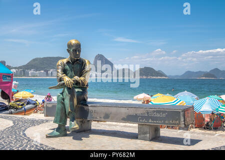 Carlos Drummond de Andrade statua a Copacabana Beach con la montagna Sugar Loaf sullo sfondo - Rio de Janeiro, Brasile Foto Stock