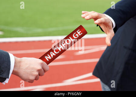 Imprenditori passando il testimone con la parola tedesca - Nachfolge Foto Stock
