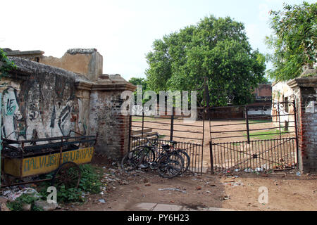 Traduzione: Il vecchio e abbandonato risciò bicicletta e di fronte a un cancello in Varanasi. Preso in India, Agosto 2018. Foto Stock