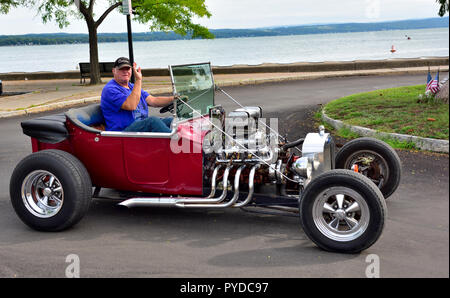 La mezza età uomo alla guida è fatta in casa hot rod auto, Canandaigua NY, STATI UNITI D'AMERICA Foto Stock