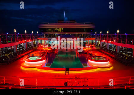 Mare Mediterraneo, 14.10.2018: la piscina a bordo di Norwegian Cruise Line illuminata di notte Foto Stock